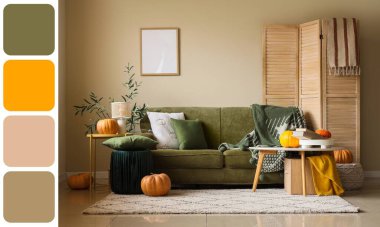Interior of light living room with green sofa, tables and autumn pumpkins. Different color patterns