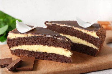 Tahta tahtada beyaz arka planda çikolatalı pasta parçaları var.