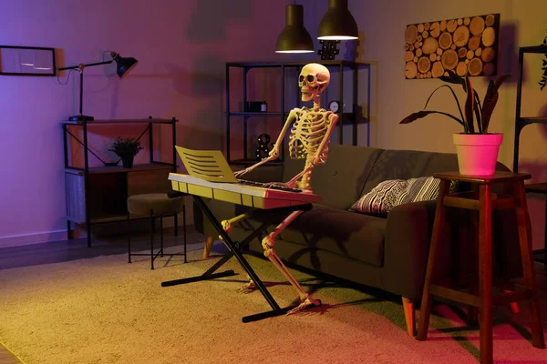 Human skeleton model with synthesizer in dark living room