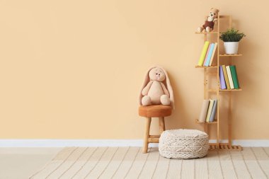 Interior of children's room with bookshelf, toys and poufs