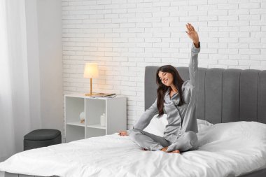 Evdeki yatakta uzanan güzel bir kadının sabahı.