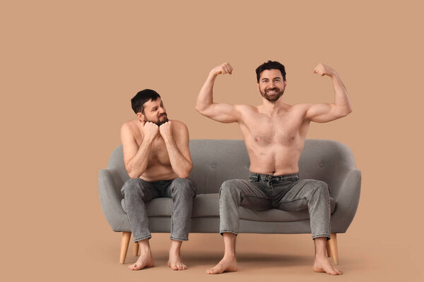 Man being envious of another guy's muscles on beige background. Body positive concept