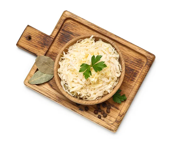 Lezzetli lahana turşulu ahşap kase ve beyaz arka planda farklı baharatlar.