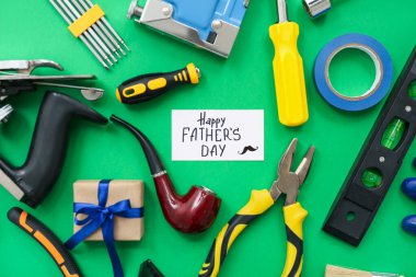 Yeşil arka planda Babalar Günü 'nüz kutlu olsun yazılı araçlar ve tebrik kartı