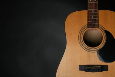 Siyah arkaplanda modern akustik gitar, yakın plan