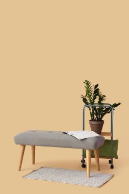Açık kitaplı gri bank ve bej arka planda ev bitkisi