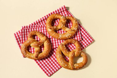 Bej arka planda peçete ve lezzetli krakerlerle kompozisyon, yakın plan