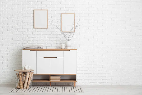 Beyaz tuvaletli, tablolu ve boş çerçeveli odanın içi