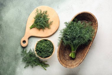 Hasır kase ve ahşap tahta, arka planda taze yeşil dereotu var.