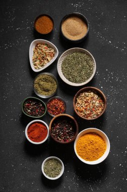 Koyu arkaplanda bir sürü taze baharat içeren kompozisyon.