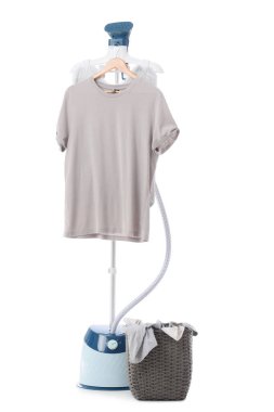 Beyaz arka planda tişört ve çamaşır sepetli modern buharlı gemi.