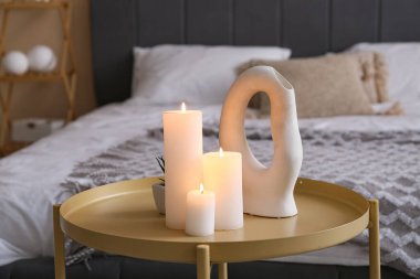 Yatak odasındaki sehpada mum yakmak. Yakın çekim.