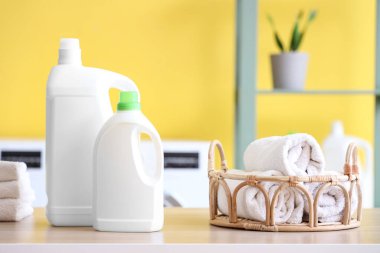 Odada havluları olan çamaşır deterjanı şişeleri.