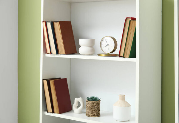 Book shelf near green wall in room