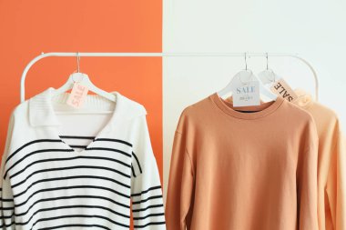 Sweatshirt ve satış etiketlerini renk arkaplanına yerleştir