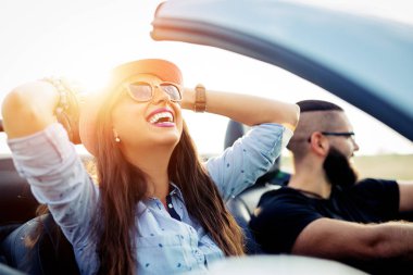 Açık yol özgürlüğü. Genç çift üstü açık araba ülkede yol boyunca sürüş