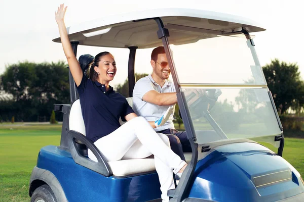 Couple Smiling Driving Buggy Golf Course — Stock Photo, Image