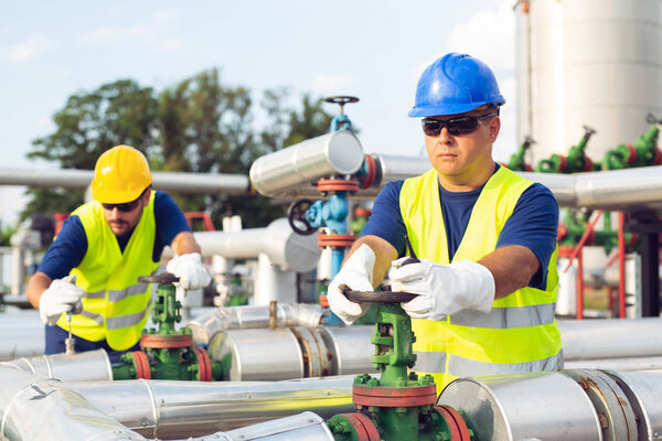 Two engineers working inside oil and gas refinery