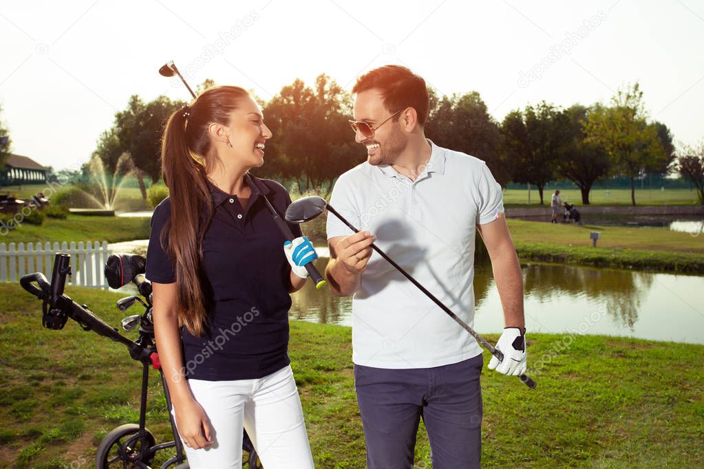 Happy couple feeling happy after golf game. - Image