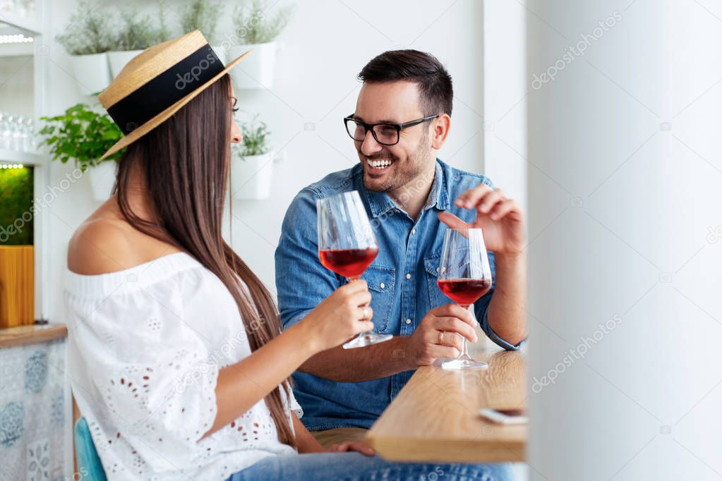 Couple romantic date drink glass of red wine at restaurant. 