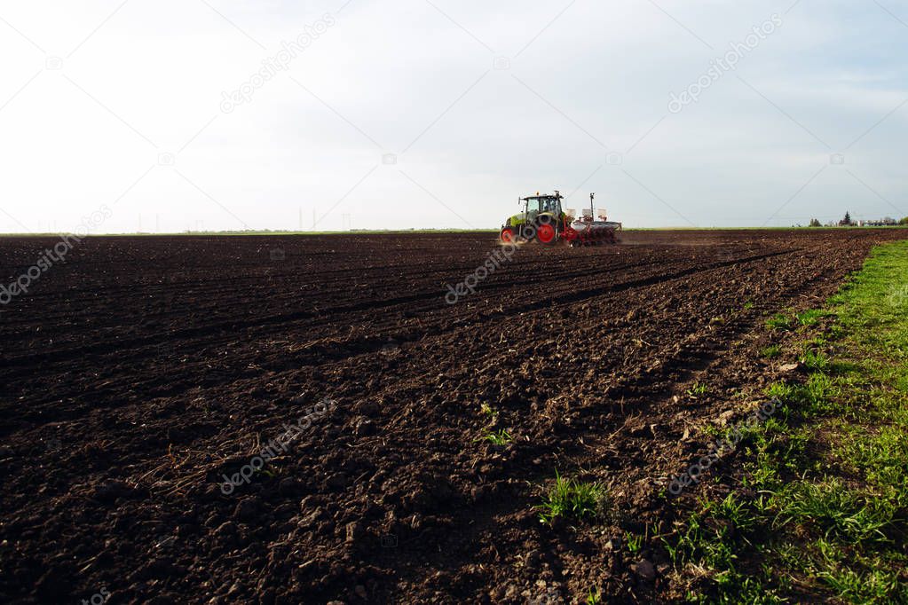 Farmer seeding crops at field. - Image