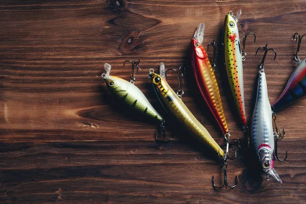 Flat lay of bass lure fishing tackle on a plain wooden background Stock  Photo - Alamy