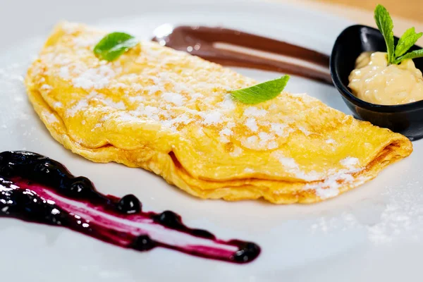 Pancake with chocolate and blackberry