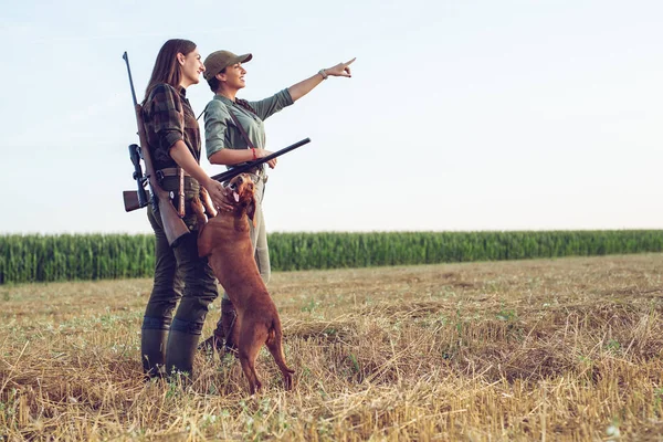 Women hunters with hunting dog