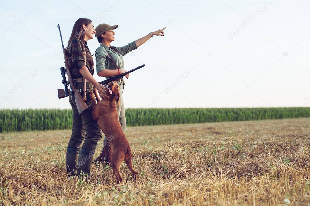 Women hunters with hunting dog 