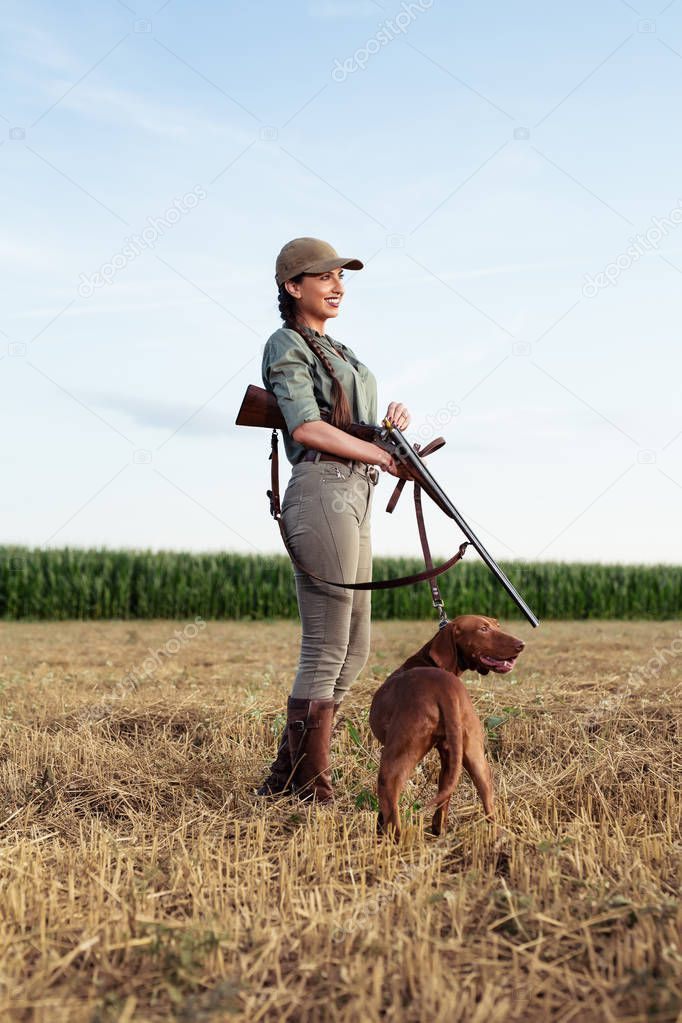 Beautiful female hunter with furry companion.