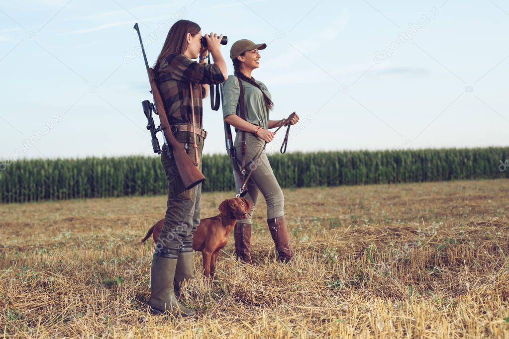 Women hunters with hunting dog 