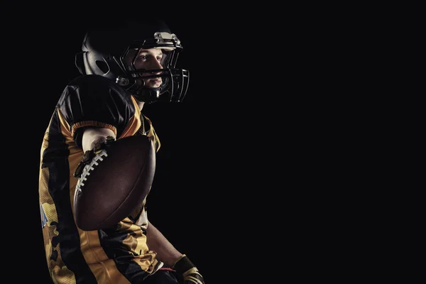 American football player isolated on black background