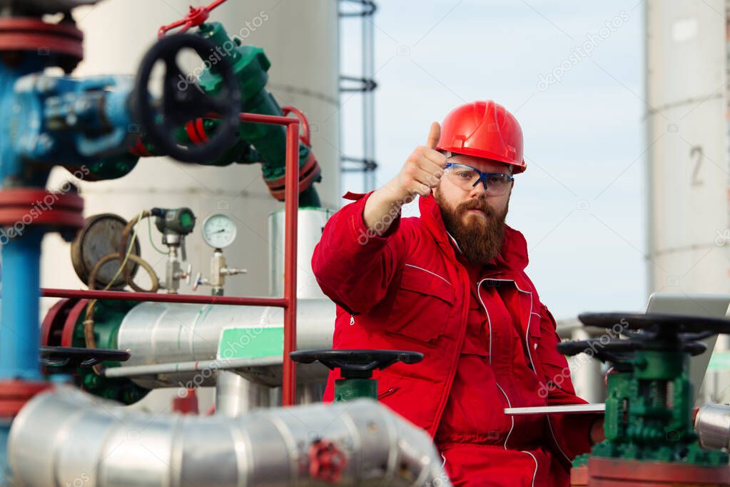 Oil industry of an engineer making a report on a computer.