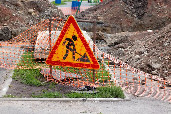 Road works sign, hazardous area fencing. Communal accident, pits and embankments