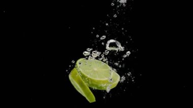 Sliced Lime Falling Into Water