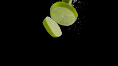 Sliced Lime Falling Into Water