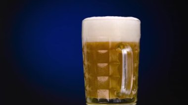 Glass Beer on Blue Light Background 