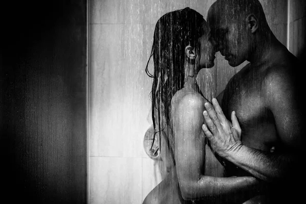 Young beautiful couple makes love in shower