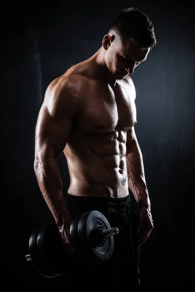 Athletic shirtless young male fitness model with dumbbells — Stock Photo, Image