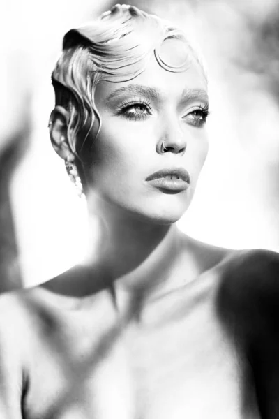 Ομορφιά πορτρέτο του νεαρού ελκυστικό μοντέλο μόδας με κοντά βρεγμένα ξανθά μαλλιά. Φρέσκο, καθαρό δέρμα. Μπλε μάτια, επαγγελματικό μακιγιάζ. Ασπρόμαυρο, μονόχρωμο. Φυσικό φως και σκιές σε εσωτερικούς χώρους — Φωτογραφία Αρχείου