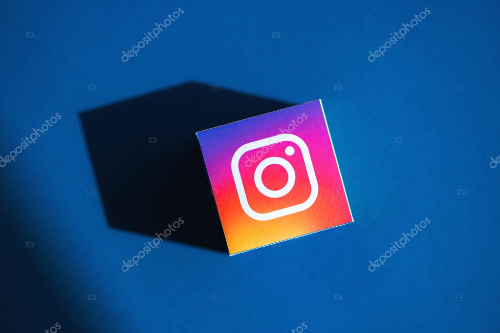 Kyiv, Ukraine - September 5, 2019: A shot from above of paper cube with the printed logotype of the Instagram application, that placed on a blue background.