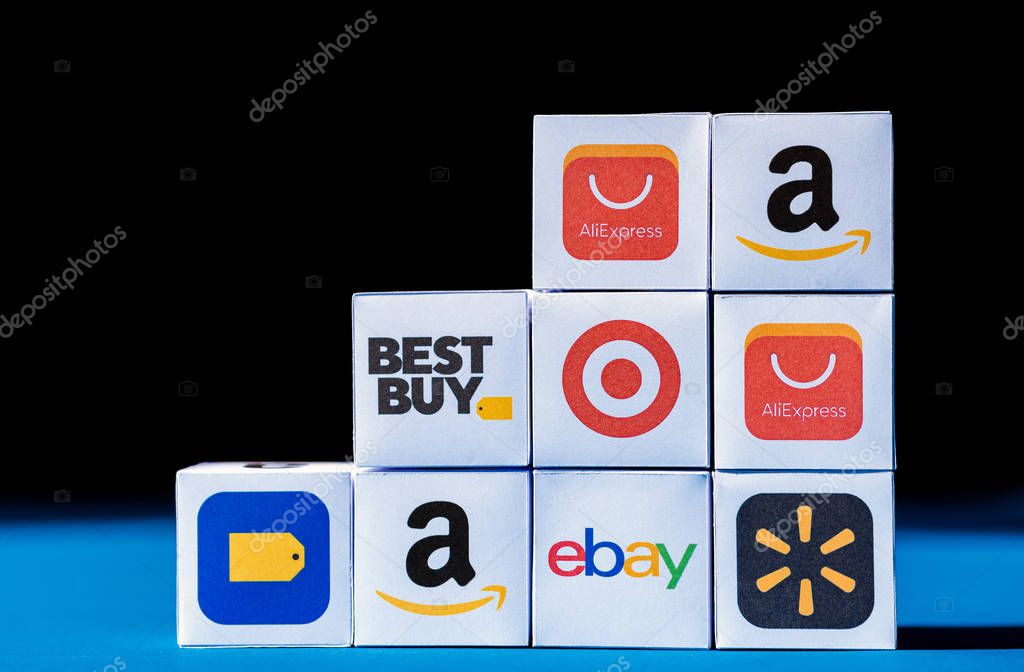 Kyiv, Ukraine - September 10, 2019: A wall from paper boxes with printed logos of eCommerce corporations and online retail stores, such as eBay, AliExpress, Best Buy, Amazon, and others.