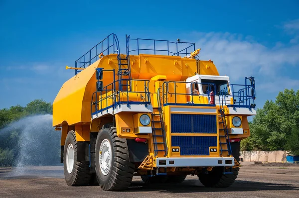 heavy yellow dump truck at repair station at sunny cloudless day