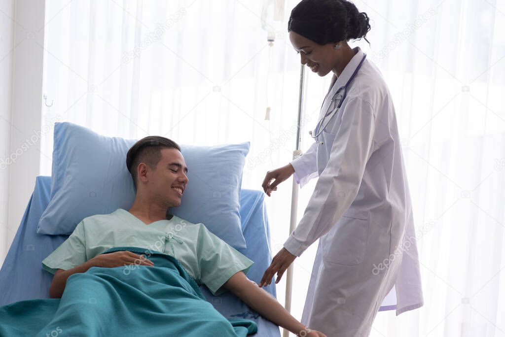 Female Doctor With Male Patient In Hospital 