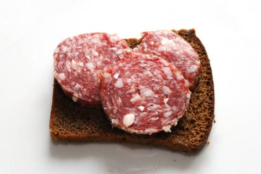 Üç parça kuru sosis ve bir parça siyah ekmek..