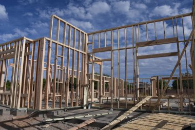 Framing of a new home being built in which is the first step of building a home from the construction company starts in. this photo was taken in Gilbert Arizona in the Southwest part of the United States. clipart