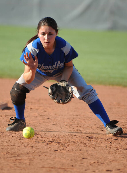Girls High School Softball game action being played at a high school level in Arizona. The game was played at a local school in Gilbert Arizona which is located in the Southwest part of the United States.