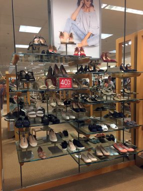 Large selection of women's shoes on a shelf for sale for women to look at in a Dillard's department store in the Chandler Mall in Chandler Arizona. clipart