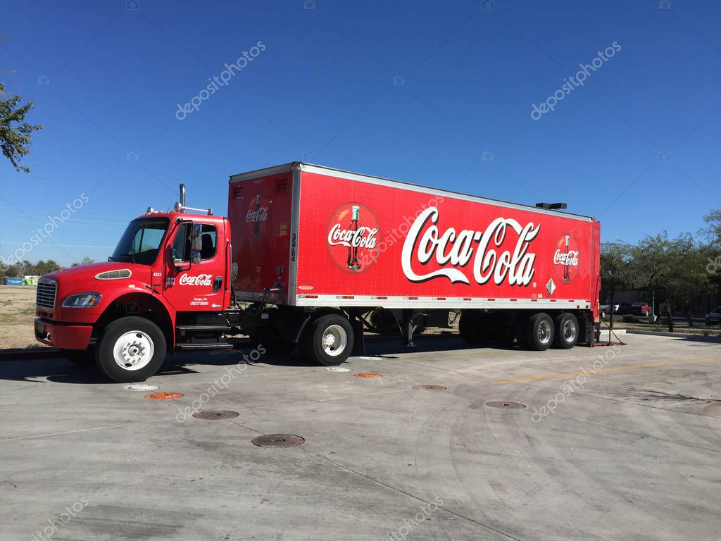 Coke Cola Truck sign on a delivery truck bringing Coke Cola to a store for sale. Coca-Cola, or Coke, is a carbonated soft drink manufactured by The Coca-Cola Company. Originally intended as a patent medicine, it was invented in the late 19th century.