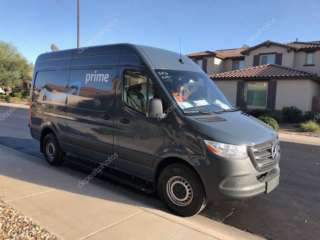 Amazon Prime Delivery being made in a residential area of Gilbert, Arizona. Amazon Prime members in over 8,000 cities and towns can get either Free Same-Day Delivery or Free One-Day Shipping.
